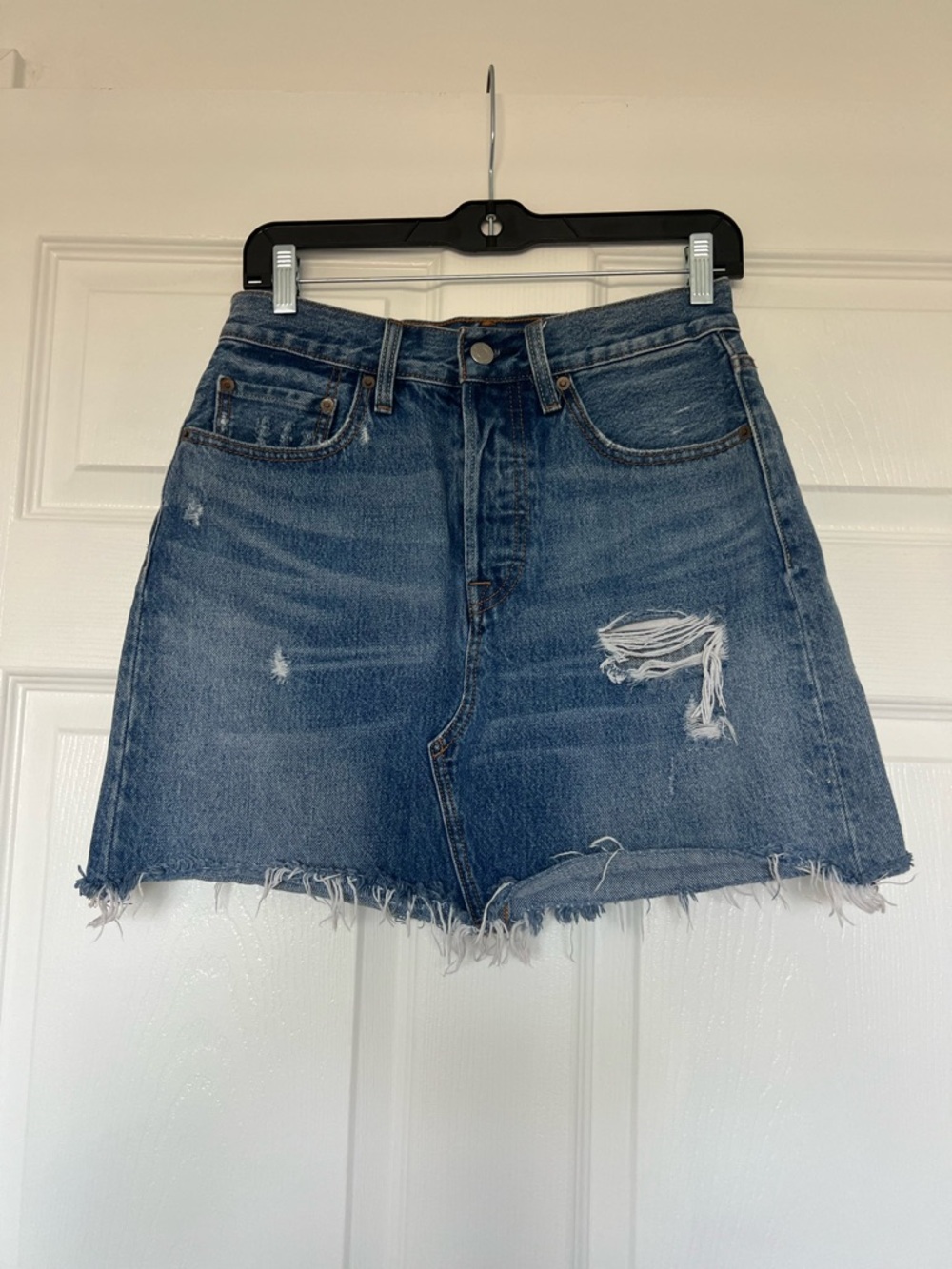 Levi's distressed high-rise denim mini skirt with a raw edge hem. Size 27